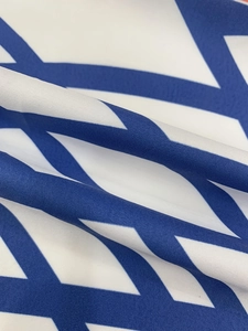 Detailed view of durable polyester fabric featuring blue Star of David print with twill texture