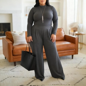 Detail of dark grey two-piece set featuring slim long-sleeve top and wide-leg trousers