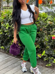 Women plus size green sweatpants and white V-neck t-shirt with trendy accessories