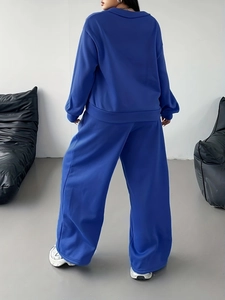 Women's navy blue lounge set featuring oversized hoodie and wide-leg trousers back view
