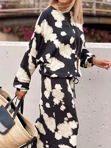 Elegant two-piece black and white tie-dye lounge set with long sleeves and loose trousers