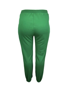 Detail view of green plus-size joggers featuring elastic waistband and soft knit fabric
