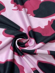 Detail of soft camouflage knit fabric with pink and magenta pattern texture