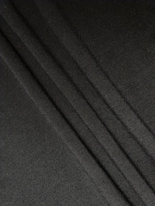 Detail of elegant black pleated fabric with fine vertical textures and high elasticity