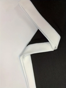 Close-up of elegant knit fabric texture with contrasting white ribbed piping detail