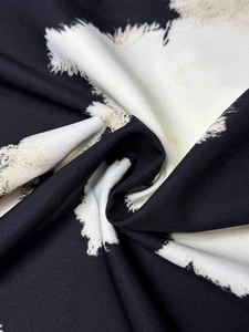 Close-up of black and white feather print fabric showing premium woven texture