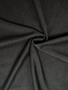 Close-up detail of smooth black woven fabric texture with elegant soft drape and finish
