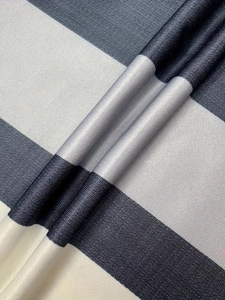 Detail of high-density navy and white striped fabric showing thick twill texture and drape