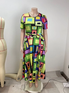 Detail of vibrant geometric block print on short sleeve maxi dress with waist tie belt