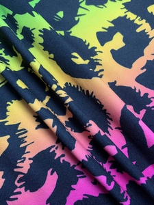 Close-up of vibrant neon gradient leopard print on soft knit fabric with deep base