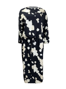 Detailed view of the drawstring waist and elastic cuffs on a black tie-dye maxi dress