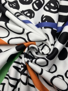 Macro view of colorful abstract print fabric with geometric patterns and soft texture