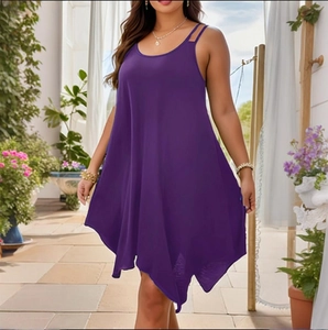 Detail of plus size dark purple dress featuring a flowy irregular handkerchief hemline