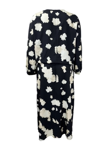 Rear view of a black maxi dress featuring an elegant white irregular abstract print