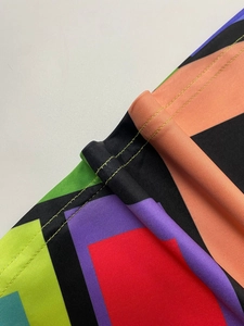 Detail of colorful geometric pattern dress with high-quality dual-needle stitching edges