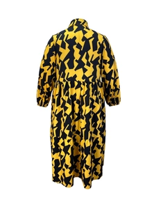 Macro detail of the geometric abstract print and elastic cuffs on a long sleeve dress