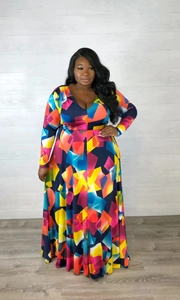 Detail of plus size maxi dress with vibrant geometric prints and elegant V-neck design
