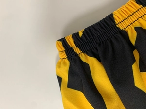 Close-up of elastic waistband with double-needle stitching on yellow striped fabric
