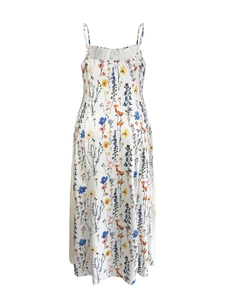 Detail of white maxi dress featuring colorful floral patterns and thin spaghetti straps