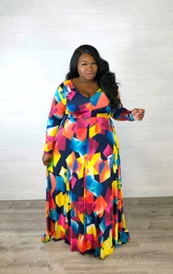 Detail of plus size maxi dress featuring vibrant geometric print and a classic V-neckline