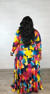 Back view of long sleeve maxi dress featuring colorful geometric abstract print and flowy hem