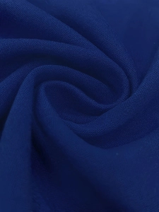 Macro shot of dark blue polyester fabric with fine woven texture and soft drape detail