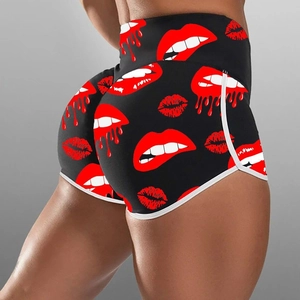 High-waisted black athletic shorts with red lip prints and white contrast piping accents