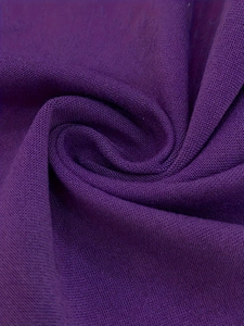 Detailed close-up of dark purple knit fabric showing breathable pique mesh texture