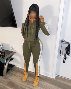 Detail of army green tracksuit showing side stripes on the cropped hoodie and joggers