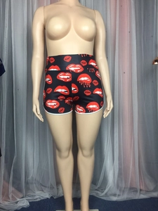 Detail view of high waisted sports shorts with red lip prints and white contrast piping
