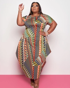 Detail of plus size short sleeve dress showing vibrant geometric print and irregular hem