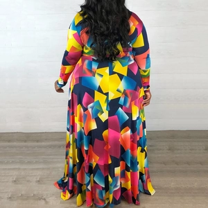 Detail of plus size maxi dress featuring vibrant geometric color block print and full skirt