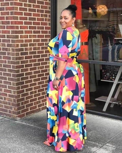 Detail of colorful geometric print maxi dress with long sleeves and cinched waistline