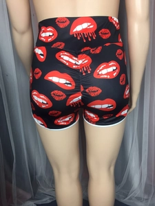 Close-up of high waist sports shorts featuring red lip print and scrunch butt lifting detail