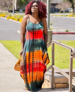 Detail of vibrant tie-dye summer maxi dress with thin straps and loose flowing skirt