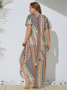 Detail of plus size maxi dress with colorful geometric stripes and side slit design