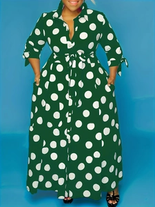 Front view of a dark green polka dot maxi dress with shirt collar and waist tie