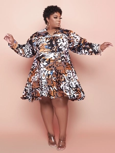 Detail of V-neck ruffled hem and abstract print on this loose plus size mini dress