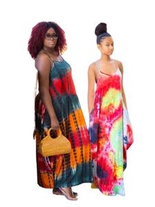 Detail of vibrant sleeveless tie-dye maxi dresses featuring a loose fit and colorful patterns