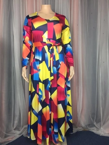 Close-up of vibrant geometric print maxi dress with tie waist and silky fabric detail