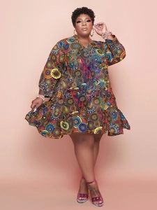 Full view of floral print V-neck dress with ruffled hem and African geometric patterns