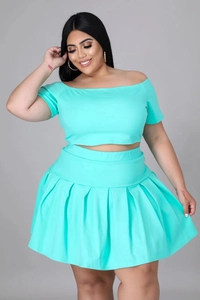 Detail of mint green plus size two-piece set with off-shoulder crop top and pleated skirt