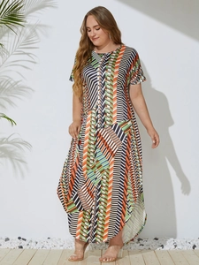 Detailed view of women plus size maxi dress featuring irregular hem and geometric print