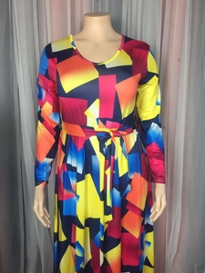 Detail of colorful geometric print maxi dress with self-tie waist belt and long sleeves