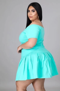 Detail of off-shoulder mint green pleated dress with elastic slim fit waistline
