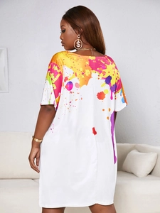 Detail of loose-fit V-neck tunic with vibrant yellow and purple ink-splash print patterns