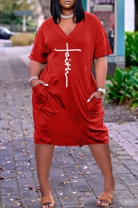 Detail of red V-neck plus size dress featuring faith print cross and side pockets