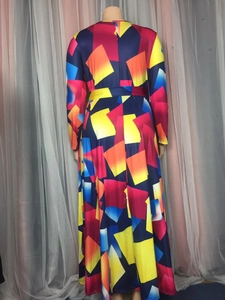 Detailed back view of long-sleeve maxi dress with colorful geometric print and waist belt