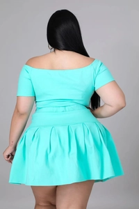 Back view of a sexy mint blue two-piece set with off-shoulder top and pleated skirt