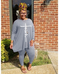 Detail of grey oversized long sleeve top with white faith cross print and matching leggings